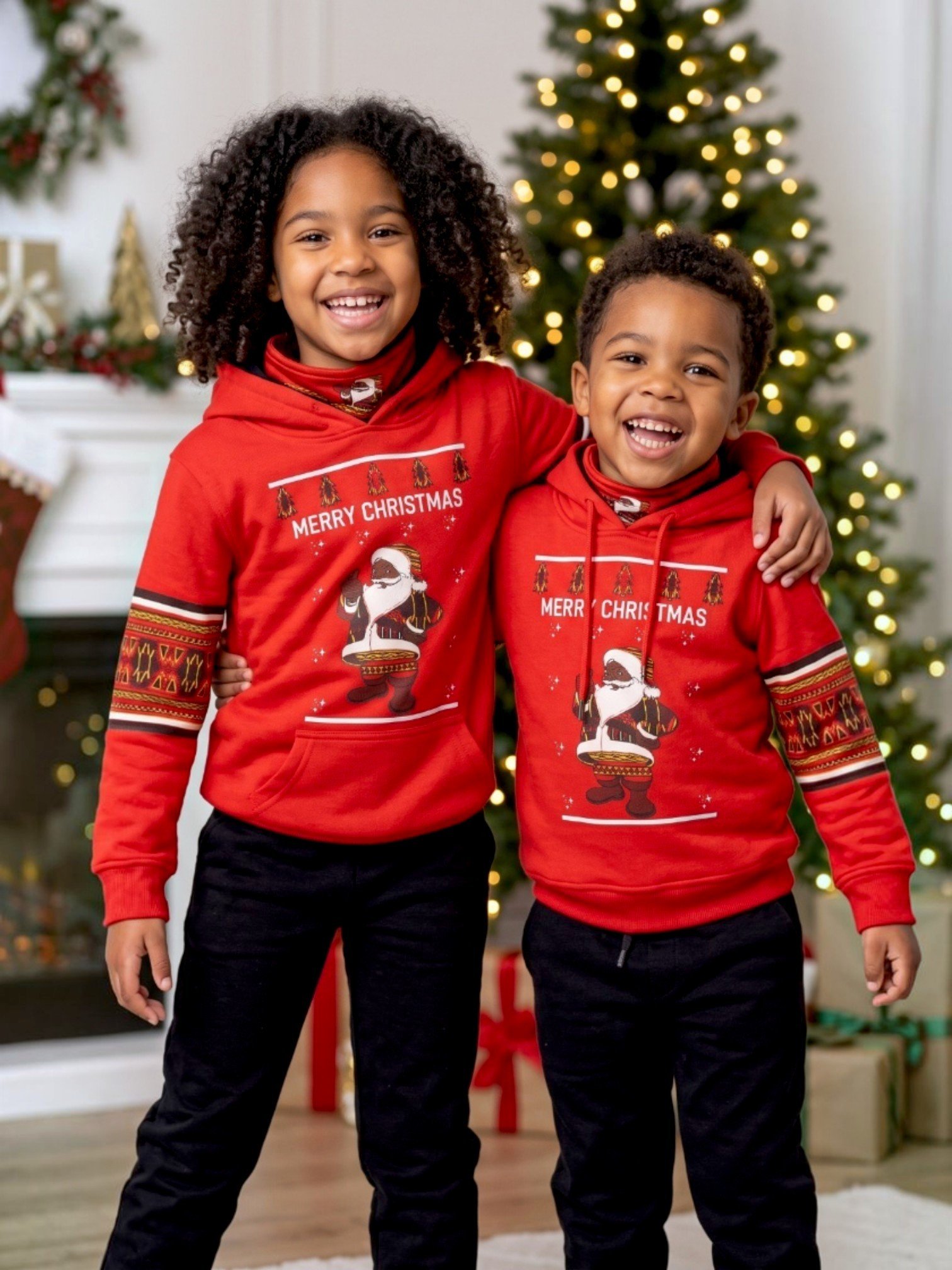 Kids Christmas hoodie – red festive hoodie worn by two children by the Christmas tree – Africstyle Fashion