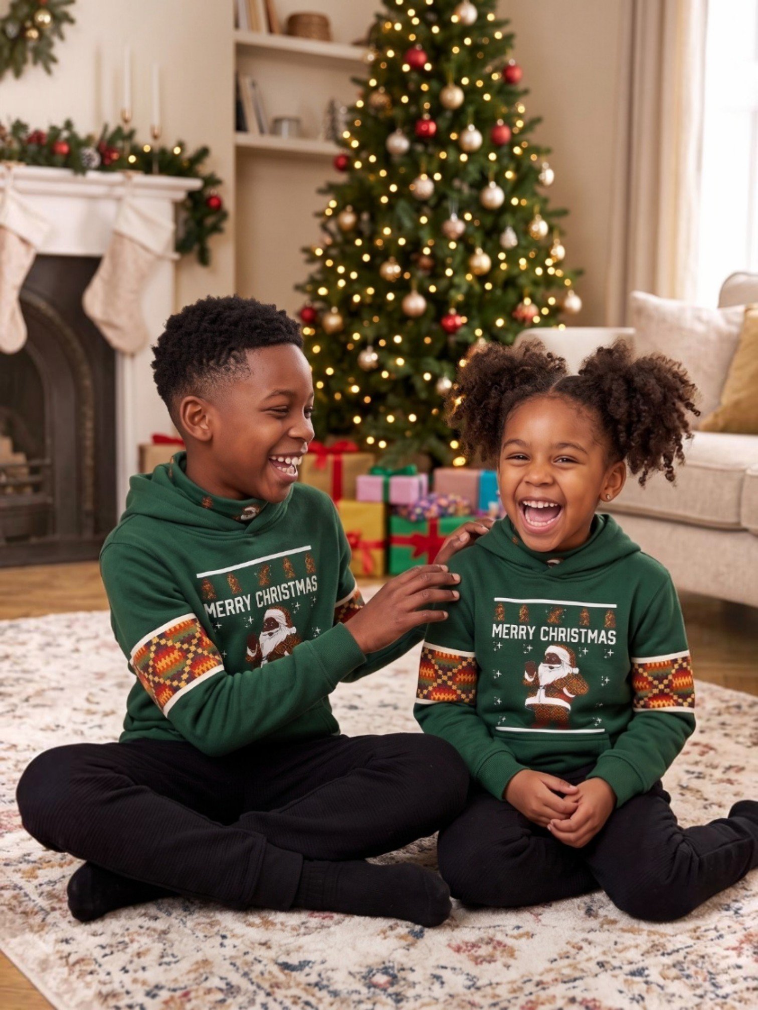 Two children in green Christmas hoodies sitting by the Christmas tree – Africstyle Fashion