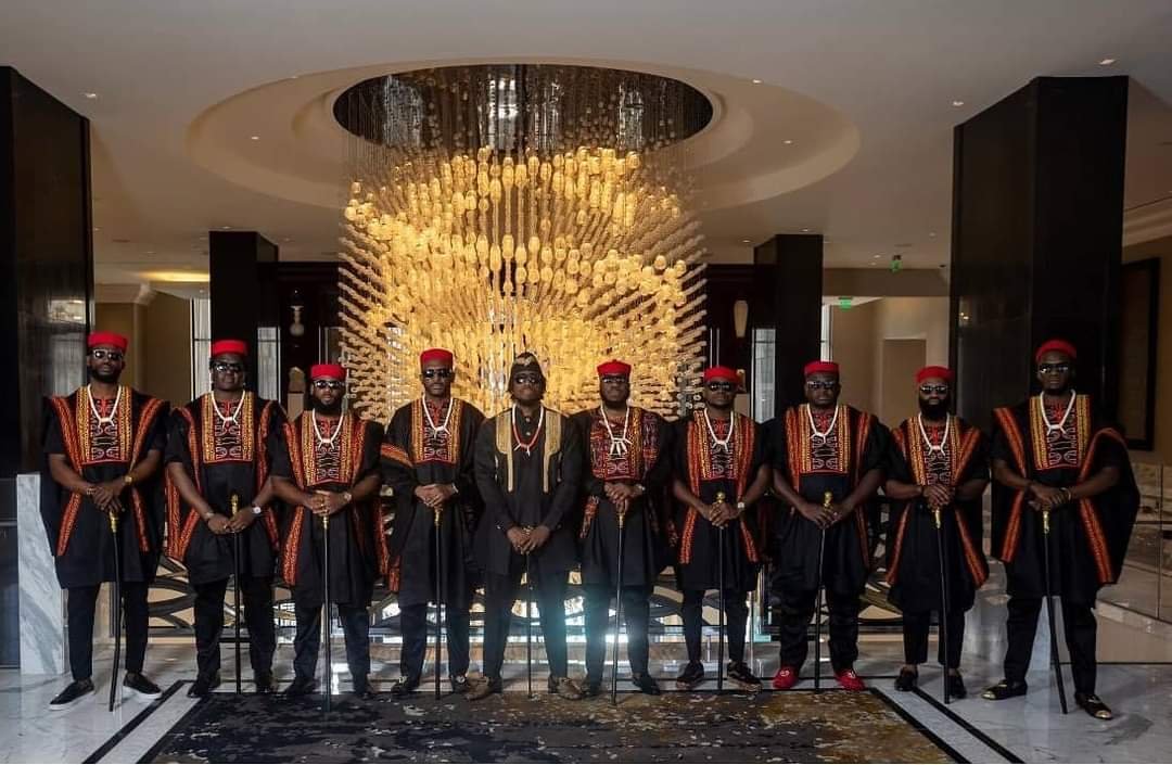 Groomsmen in Toghu outfits lined up at an African wedding