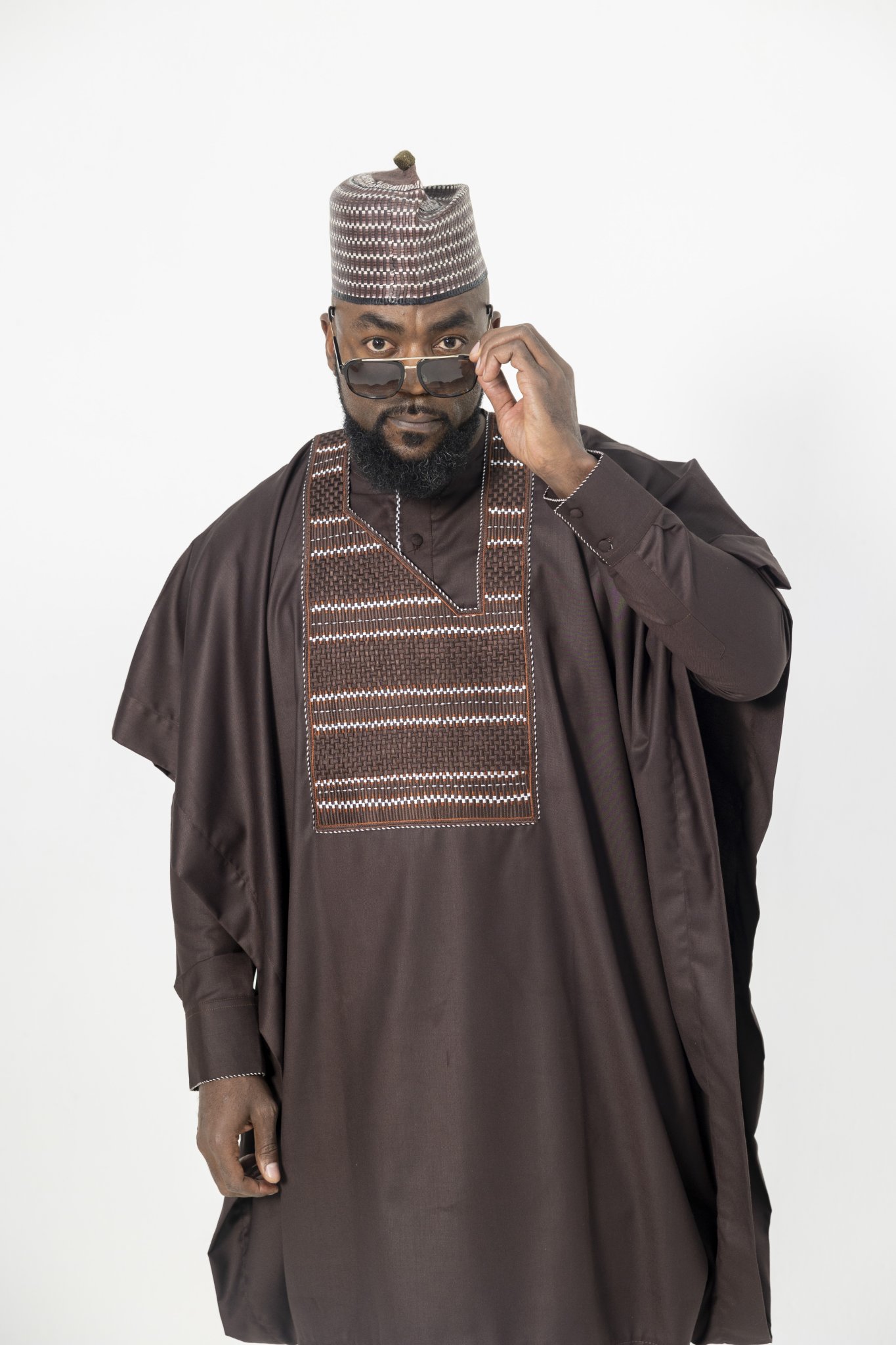Man in a brown agbada in a studio